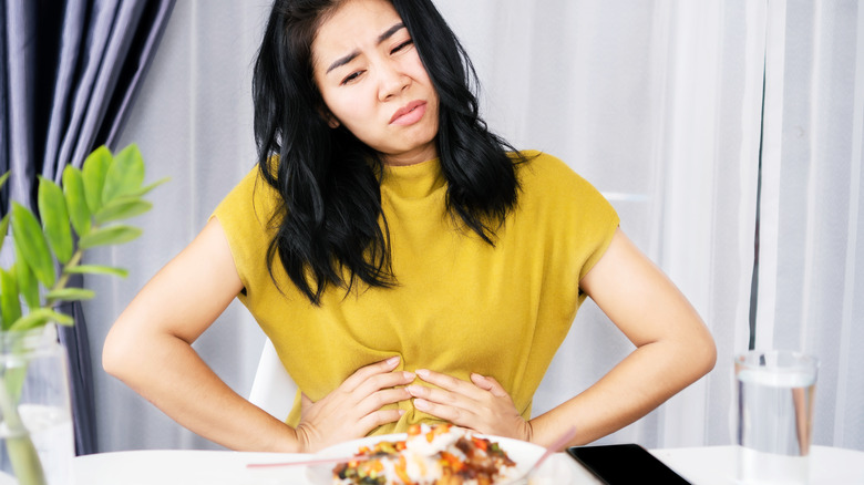 A woman feels sick after eating