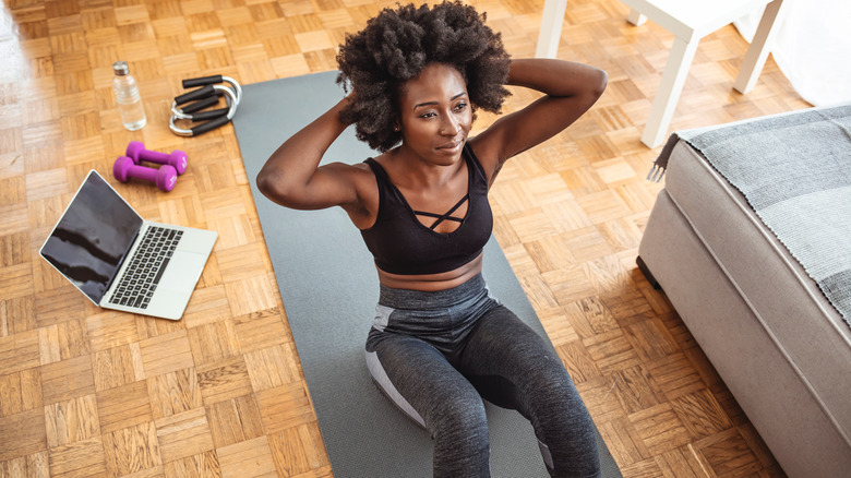 a young women doing floor work exercises 