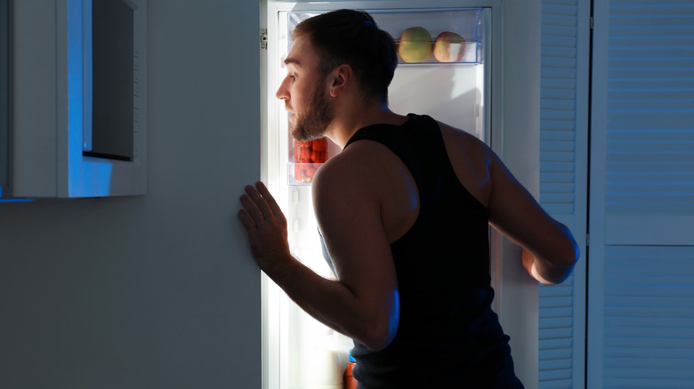 A man gets a snack before bed