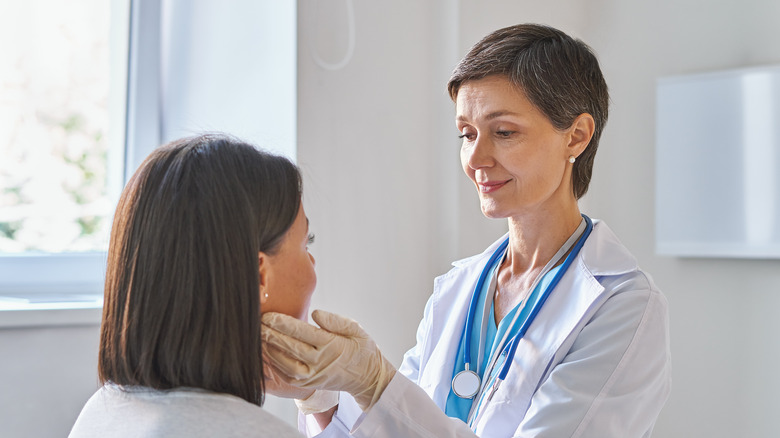 Doctor checking patient's glands