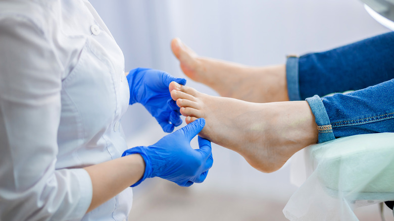Doctor examining patient foot