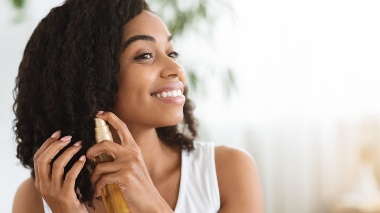 woman applying hair care product