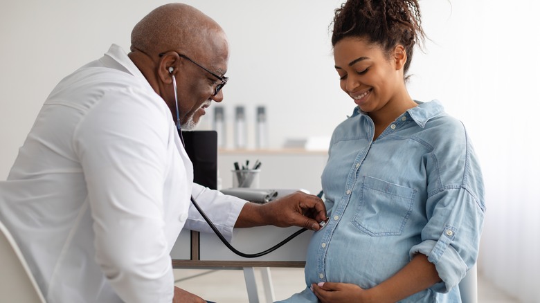 Pregnant woman with doctor