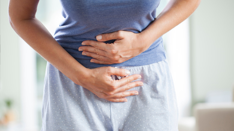 Woman holding stomach