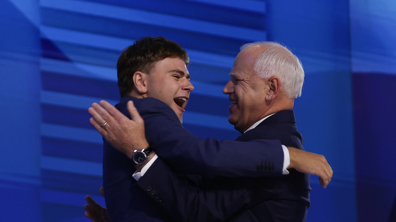 Guz Walz and Tim Walz embracing onstage at DNC