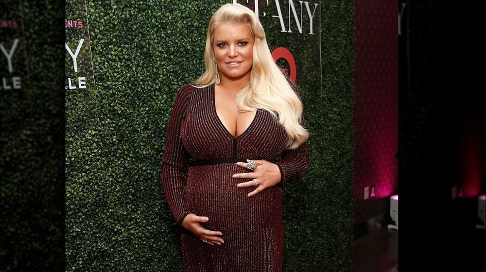 Jessica Simpson pregnant and holding belly
