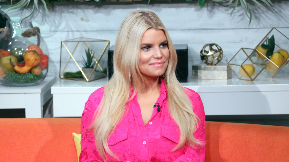 Jessica Simpson sitting on a couch