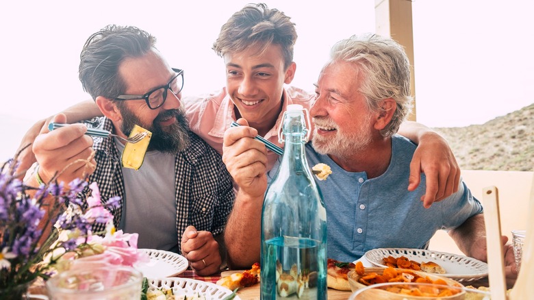 Males enjoying dinner together