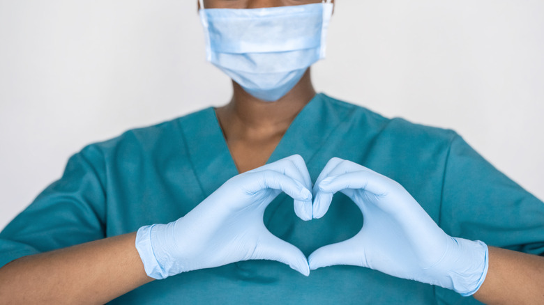 Medical provider making heart symbol