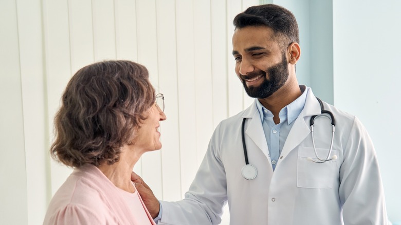 woman being assured by doctor