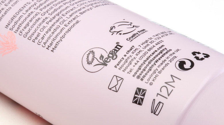 Ingredients list and vegan symbol on shampoo bottle
