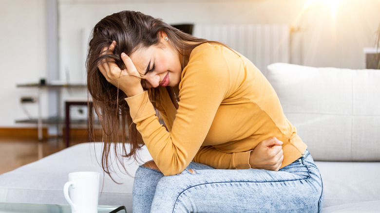 Woman holding her stomach in pain