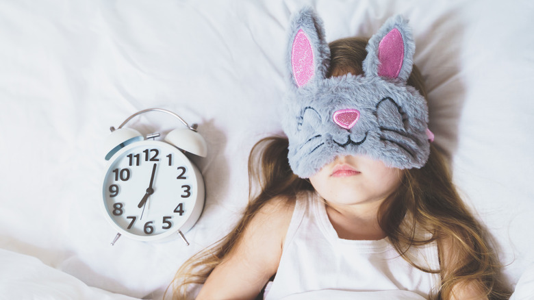 little girl with bunny eye mask