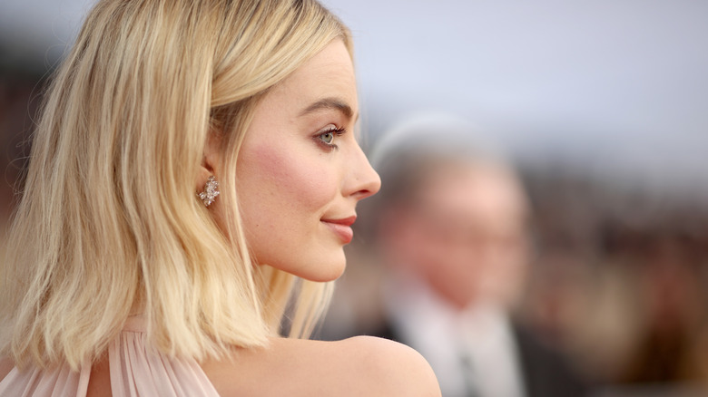 Margot Robbie in profile at an event