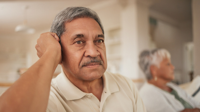 disappointed man sitting next to wife