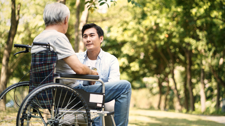 young man speaking with ill father