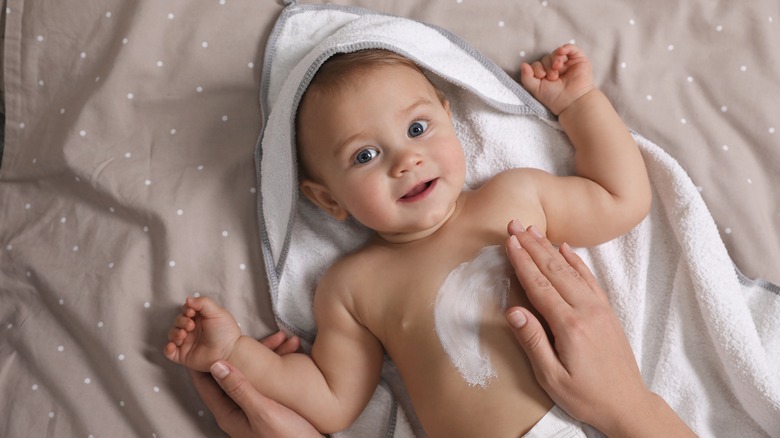 Rubbing lotion on baby's skin