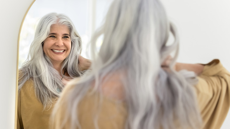 woman smiling in the mirror