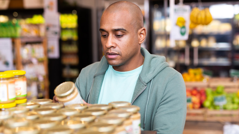 man reading food label