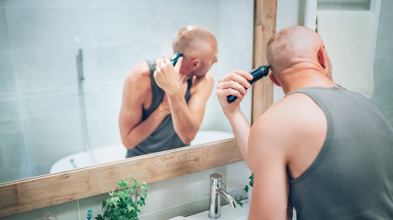 a man shaving his head