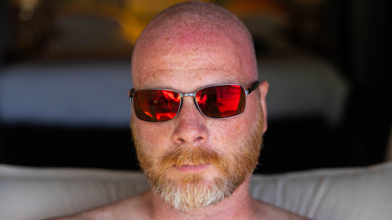 shaved head, sunglasses, and red beard