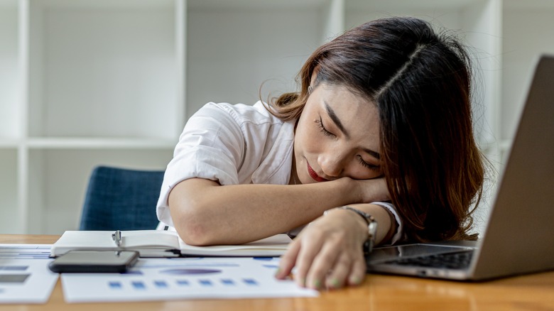 woman napping on desk