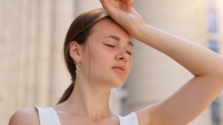 dehydrated woman with hand on forehead