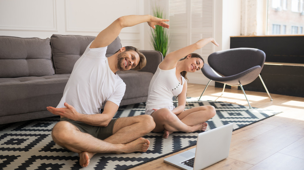 Couple doing yoga at home