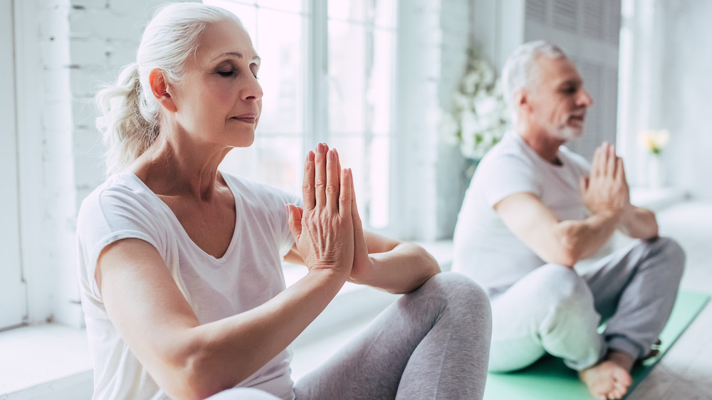 Older couple doing yoga