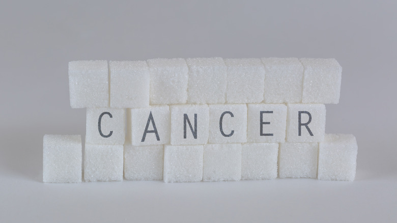 the text CANCER written on sugar cubes