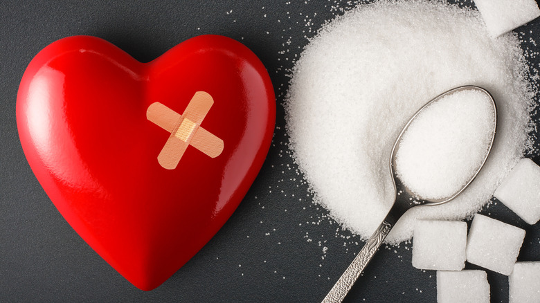 heart with bandage and spoon with sugar