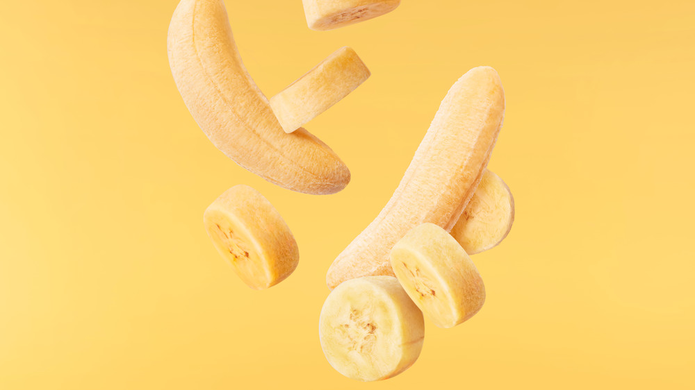 bananas falling on yellow background