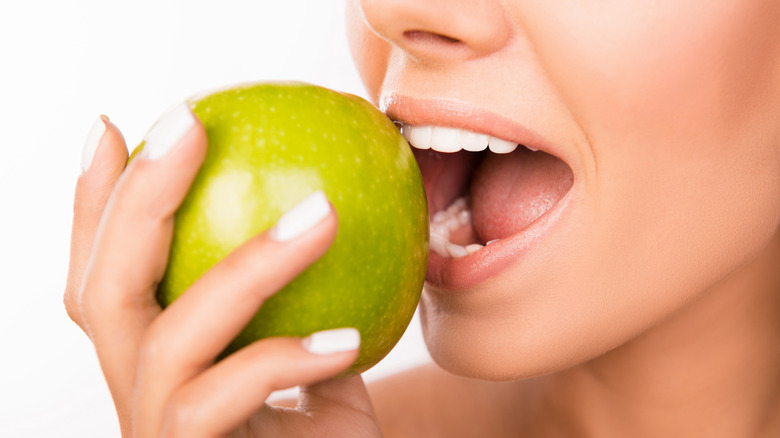 woman biting apple 