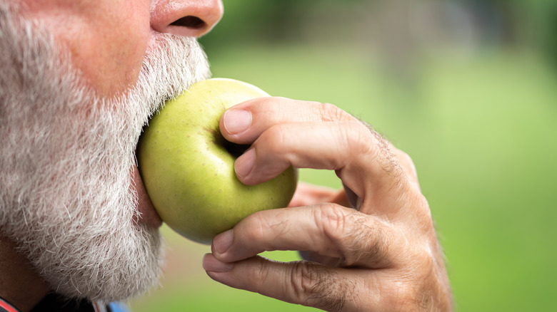 man biting apple