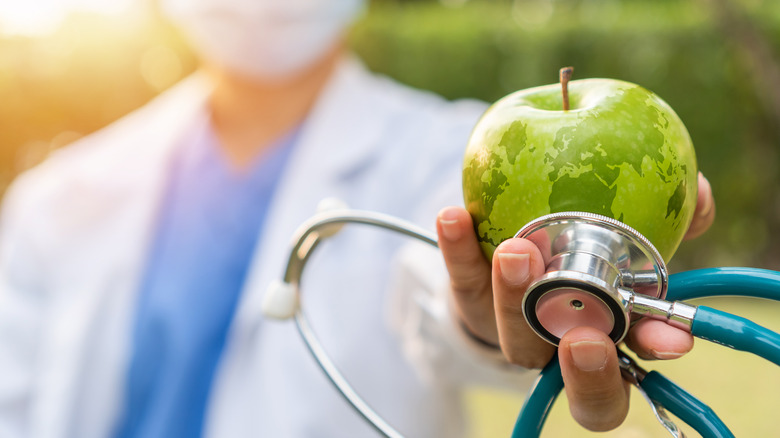 doctor holding apple 