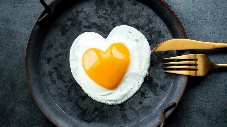 heart-shaped egg in a pan