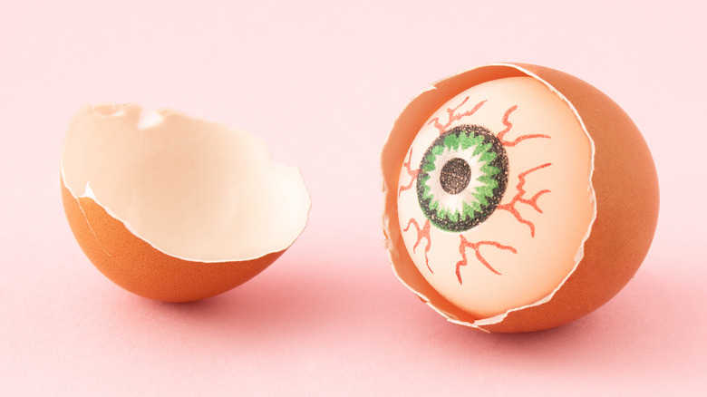 an eyeball inside egg cracked open 