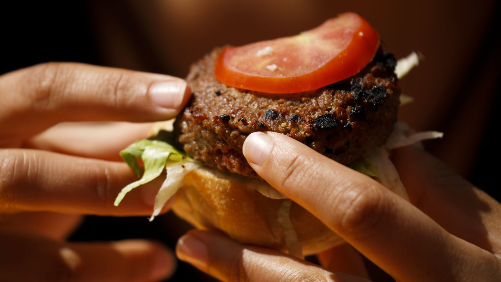 hands holding an Impossible burger