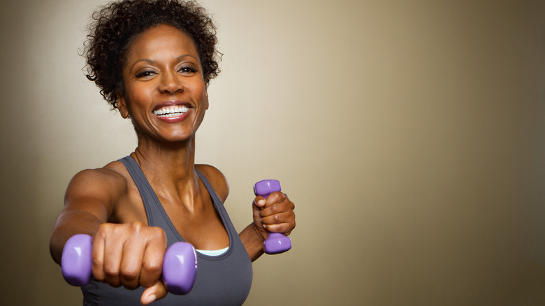 Older woman lifting hand weights