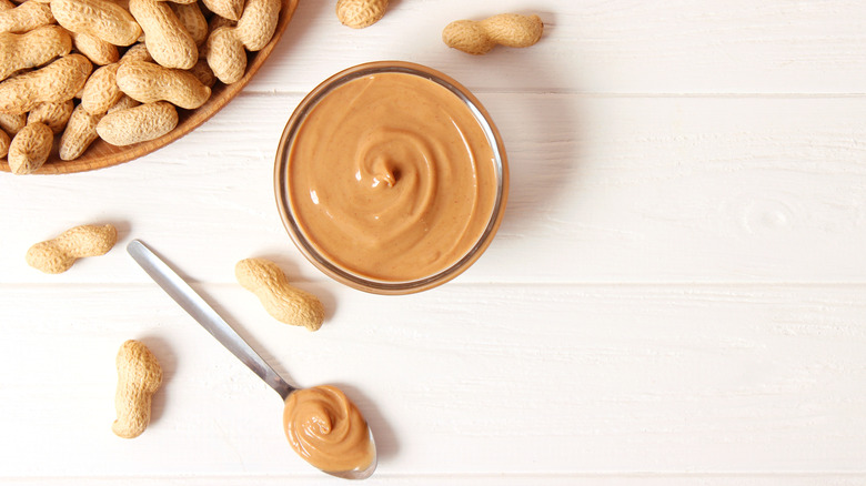 peanut butter, spoon, and peanuts