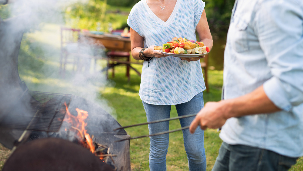 couple grilling meat