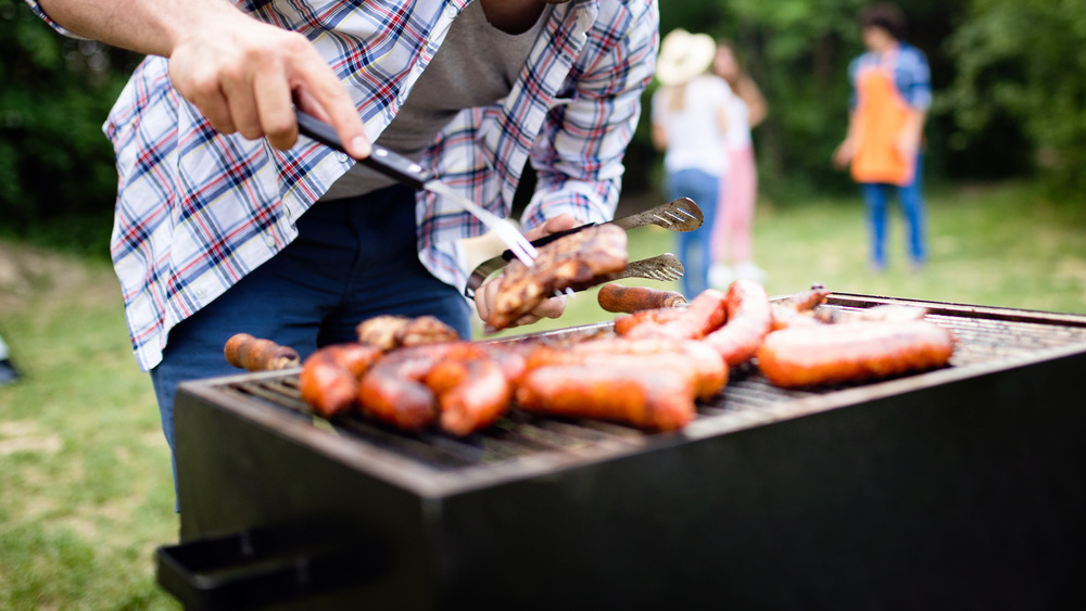 man grilling meat