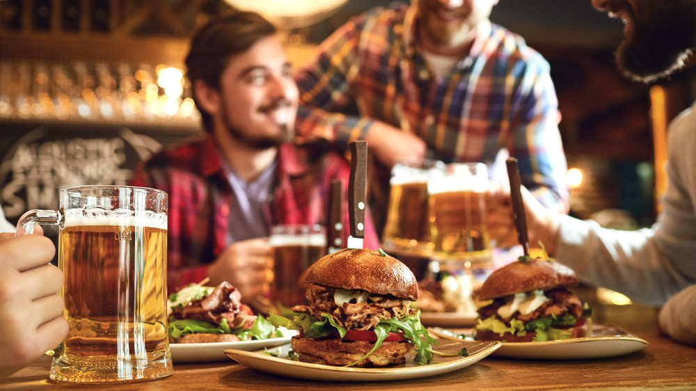 burgers and beers on table