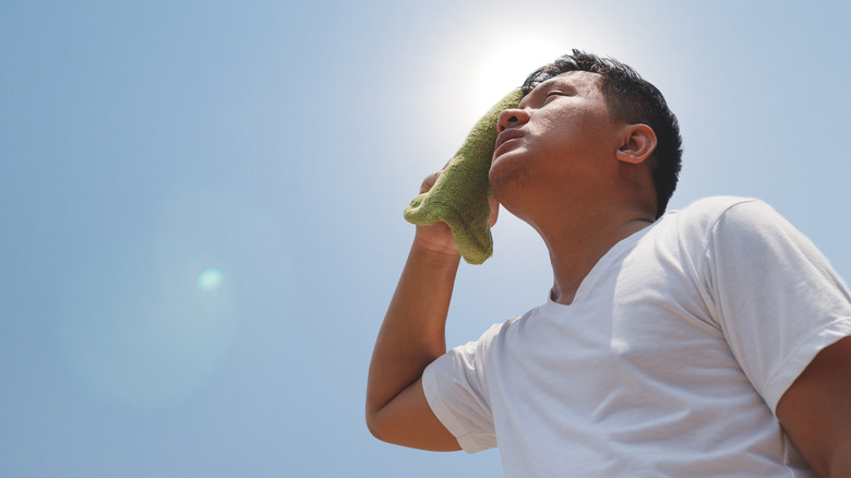 man sweating under sun