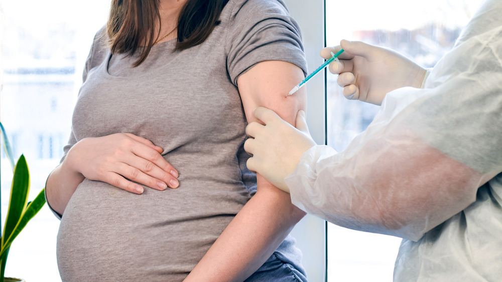 doctor giving vaccine to pregnant woman