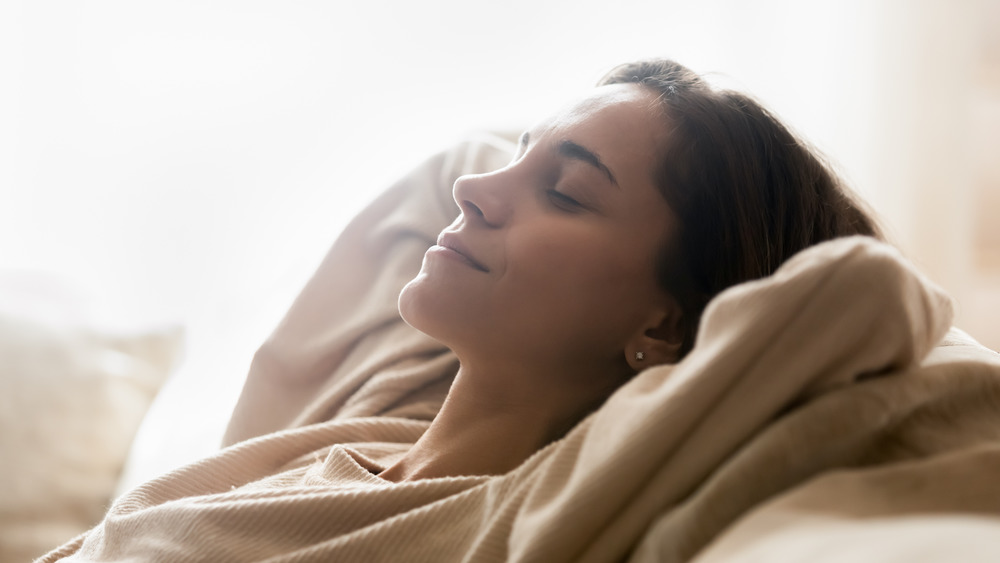 Happy woman waking up from a nap