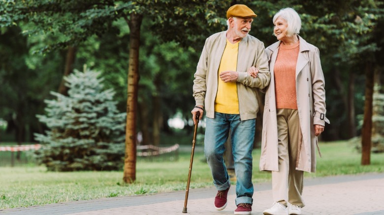 senior couple walk in park