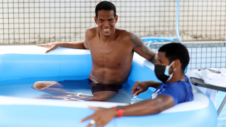 Two men in inflatable pool