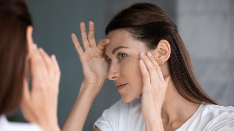 Woman framing face with hands