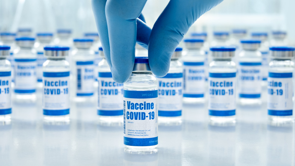 COVID vaccine vials with medical glove